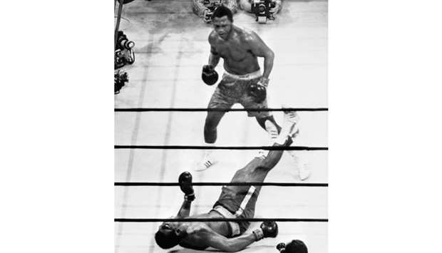 This file picture taken on March 8, 1971, shows US heavyweight boxing champion Joe Frazier (top) standing over compatriot Muhammad Ali as he wins the fight called the u201cfight of the centuryu201d at Madison Square Garden in New York. (AFP)