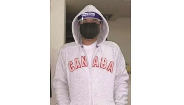 Filipino expatriate Joel Dela Cruz wears face shield and face mask against Covid-19.