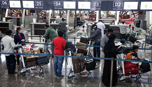 Indians queue up at the check-in counter at the Muscat International Airport ahead of their repatriation flight from the Omani capital yesterday.