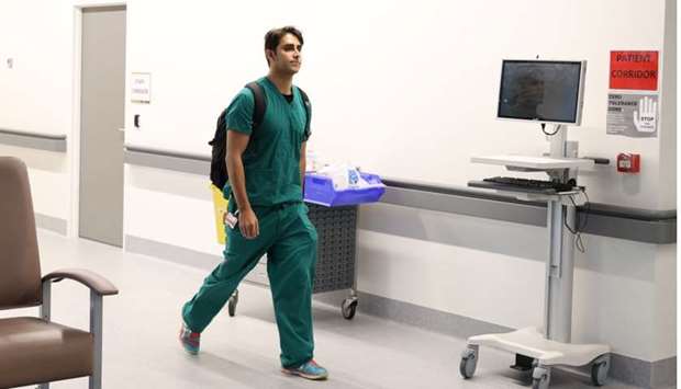 Doctor Django Nathan arrives at work before starting his shift in a coronavirus disease ward at Westmead Hospital in Sydney, Australia