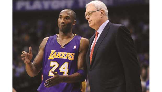 In this file photo taken on May 16, 2011, the Los Angeles Lakersu2019 Kobe Bryant (left) and head coach Phil Jackson share a few words during Game 4 of the NBA Western Conference semi-finals against the Mavericks in Dallas. (TNS)