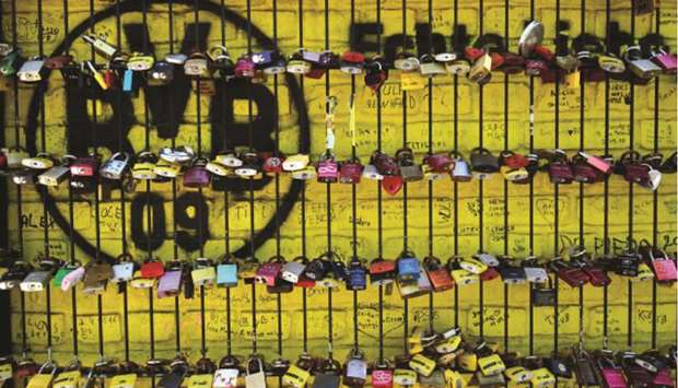 A picture taken yesterday shows love locks on a fence in front of the Signal Iduna Park stadium of Borussia Dortmund in Dortmund, Germany. (AFP)