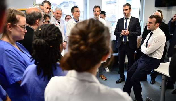 French President Emmanuel Macron and French Health Minister Olivier Veran visit the Pitie-Salpetriere hospital in Paris in this February 27 photograph.