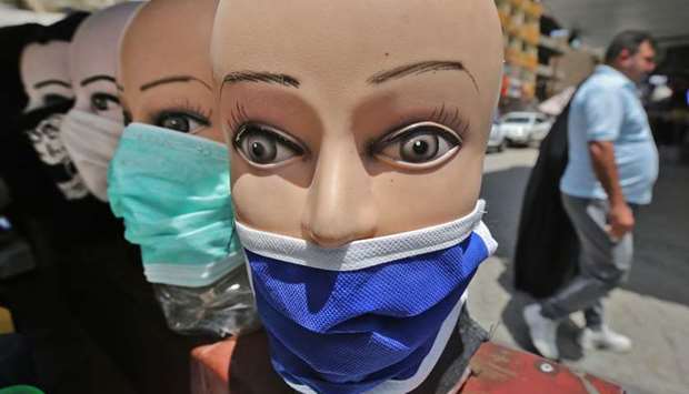 Mannequins heads wearing protective masks are picture in central Baghdad on May 14, 2020 during the holy month of Ramadan after authorities eased up the lockdown measures that they had imposed in a bid to slow the spread of the novel coronavirus Covid-19.