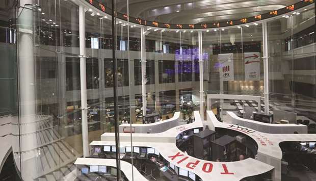 Employees work on the trading floor of the Tokyo Stock Exchange. The Nikkei 225 closed up 0.6% to 20,037.47 points yesterday.