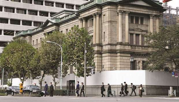 Pedestrians cross a road in front of the Bank of Japan headquarters in Tokyo. The central banku2019s ETF purchases during the first 12 days of May totalled 126.5bn yen compared with 490.4bn yen during the same period in April.