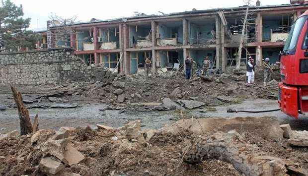 Afghan security personnel inspect the site of an attack on Afghan army base in Gardez, capital of Paktia province
