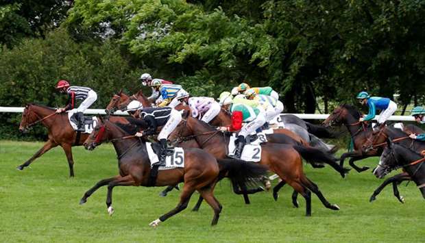 Jockeys wore protective face masks as horse racing resumed behind closed doors at Longchamp in Paris, France, on Monday. Horse Racingu2019s planned resumption in England is set for June 1. (Reuters)