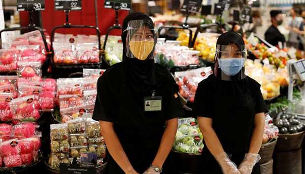 Supermarket employees wear a protective face shields and masks at a shopping mall that is getting ready to reopen amid the outbreak of the coronavirus disease, in Bangkok yesterday.