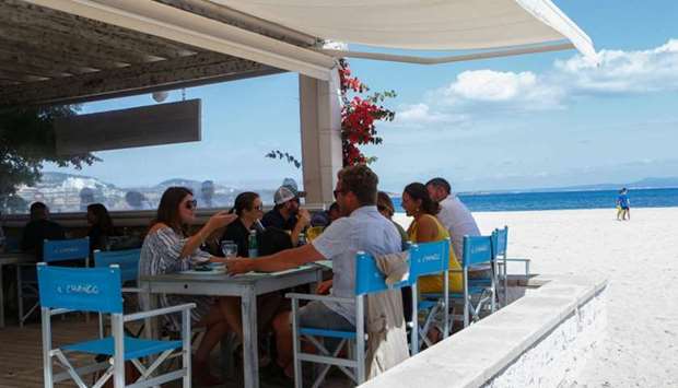 People have lunch at a beach bar and restaurant in the Son Matias beach during the coronavirus disease outbreak in Palma de Mallorca, in Mallorca Spain