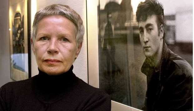 This picture taken on October 6, 2000 in Itzehoe, northern Germany, shows German photographer Astrid Kirchherr in front of one of her photographs depicting Beatles member John Lennon.