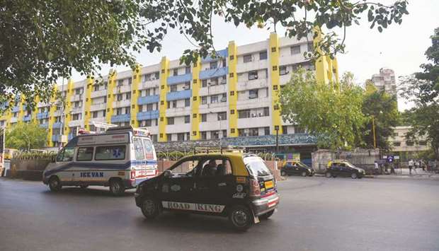 Vehicles drive past the Lokmanya Tilak Municipal General hospital in Mumbai. The state-run hospital has become a byword for the stunning failure of Mumbai to cope with the pandemic.