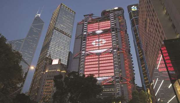 The HSBC Holdings headquarters building (centre) stands illuminated at dusk in Hong Kong. Banks in Asiau2019s financial hubs such as HSBC and Citigroup are finding that the disruption from the coronavirus outbreak is helping them push back on a threat from a new breed of virtual upstarts.