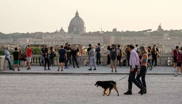 People walk on the Pincio Terrace at Villa Borghese park, in central Rome
