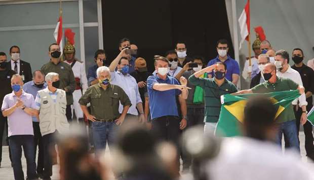Brazilu2019s President Jair Bolsonaro gestures during a protest against the president of the Chamber of Deputies, Rodrigo Maia, Brazilian Supreme Court, quarantine and social distancing measures, amid the coronavirus outbreak, in Brasilia, Brazil.