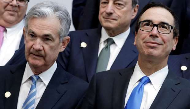 US Treasury Secretary Steve Mnuchin (R) and Federal Reserve Chairman Jerome Powell pose for G-20 finance ministers and central banks governors family photo during the IMF/World Bank spring meeting in Washington