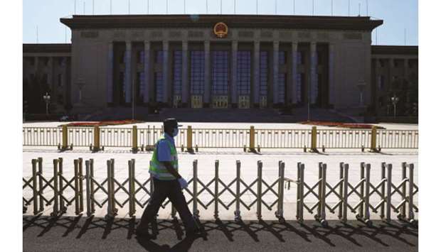 A security guard walks past the Great Hall of the People, the venue of the upcoming Peopleu2019s National Congress (NPC) in Beijing, China.