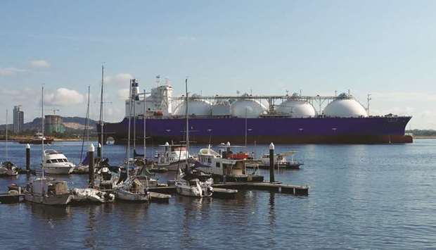An LNG tanker passes boats along the coast of Singapore (file).