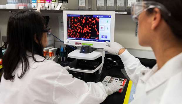 INSPECTION: Dr Sonia Macieiewski, right, and Dr Nita Patel, Director of Antibody discovery and Vaccine development, look at a sample of a respiratory virus at Novavax labs in Rockville, Maryland.