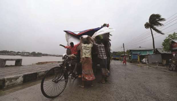 Workers unload goods from a truck ahead of the expected landfall of Cyclone Amphan, in Khulna, 271km from Dhaka, yesterday.