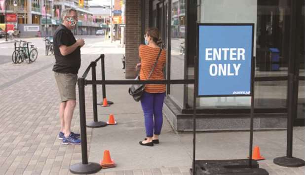 A sporting goods store clerk explains shopping rule to a customer in Ottawa.