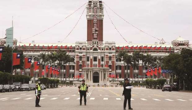 Police officers stand guard in front of the Presidential office building during the inauguration ceremony of Taiwan President Tsai Ing-wen in Taipei.