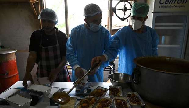 Workers pack food to be distributed in quarantine centres during a government-imposed nationwide lockdown as a preventive measure against the spread of the Covid-19 coronavirus in Srinagar in this May 18 photograph.