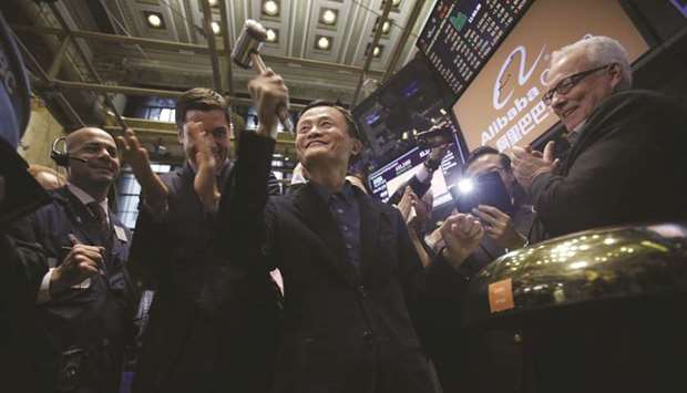 Billionaire Jack Ma, chairman of Alibaba Group Holding (centre), rings a bell during the companyu2019s IPO ceremony on the floor of the New York Stock Exchange on September 19, 2014. Now, US lawmakers have raised red flags over the billions of dollars flowing into some of Chinau2019s largest corporations, much of it from pension funds and college endowments in search of fat investment returns.