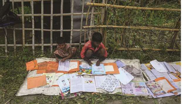 Children lay out their wet textbooks to dry following the landfall of cyclone Amphan in Khejuri area of East Midnapore, West Bengal, yesterday.