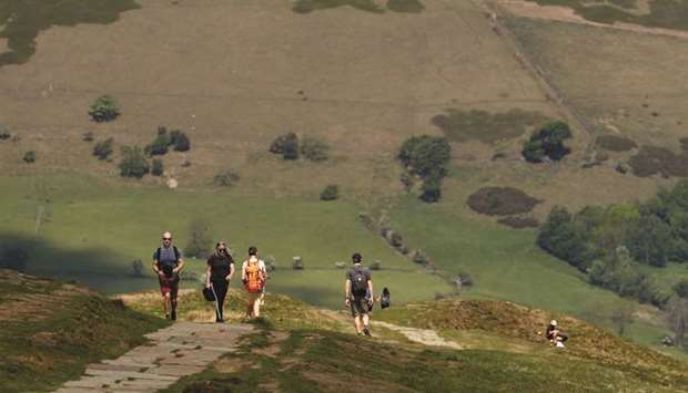 People walk on Mam Tor in the Peak District National Park, yesterday following an easing of coronavirus lockdown measures.