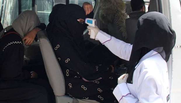 A health worker takes temperature of passengers of a van, amid fear of coronavirus disease, on the outskirts of Taiz on April 12.