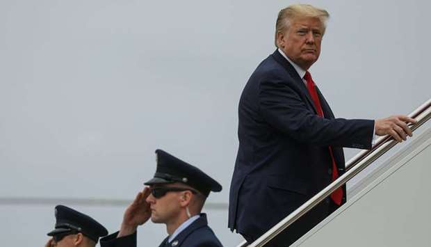 Trump boards Air Force One at Joint Base Andrews, Maryland, yesterday as he departs Washington for travel to Ypsilanti, Michigan.