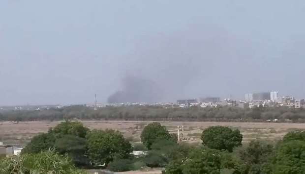 A plume of smoke is seen after the crash of a PIA aircraft in Karachi, Pakistan