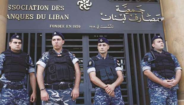 Lebanese police stand outside the entrance to the Association of Banks in downtown Beirut (file). An economic rescue plan that will form the basis of Lebanonu2019s talks with the International Monetary Fund (IMF) was panned by banks on Friday as one that would u201cfurther destroy confidenceu201d in the country.
