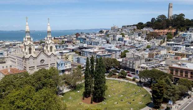An aerial view shows painted circles in the grass to encourage people to social distance at Washington Square Park, next to Coit Tower (R), in San Francisco, California, on May 22, amid the novel coronavirus pandemic