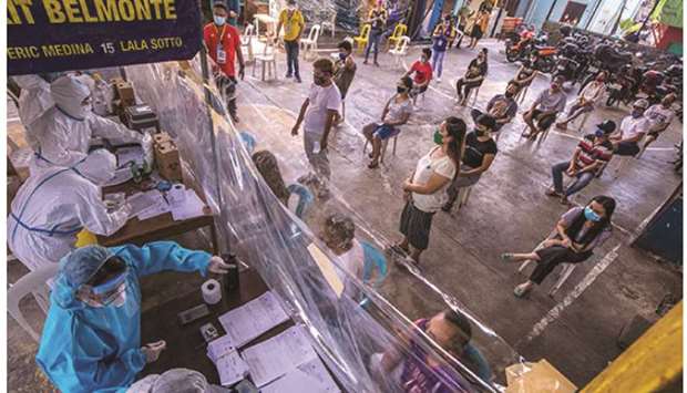 Residents of Barangay Culiat in Quezon City, observe physical distancing as they undergo the Covid-19 u2018rapidu2019 testing  at the Vargas Lane covered court during a community based mass testing.