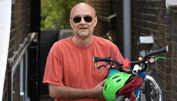 Number 10 Downing Street special adviser Dominic Cummings leaves his home carrying a childu2019s bicycle and toys in London yesterday.