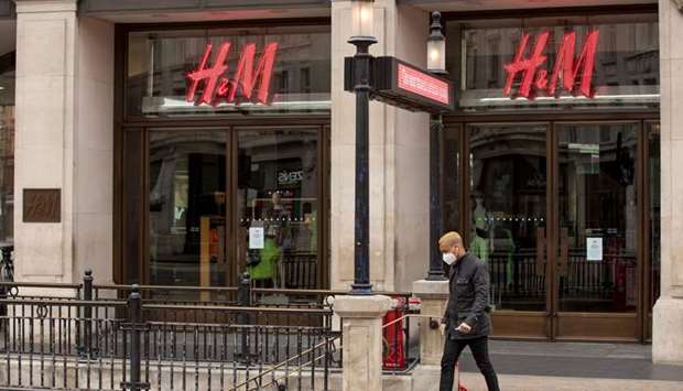 A pedestrian wearing a mask enters the London Underground system near the H&M store on Oxford Circus in London. Yesterdayu2019s borrowing and retail sales data u201cillustrates the size of the hole that the coronavirus lockdown left in the economy and how much the government has paid so far to prevent it from being biggeru201d, said Paul Dales, chief UK economist at Capital Economics.