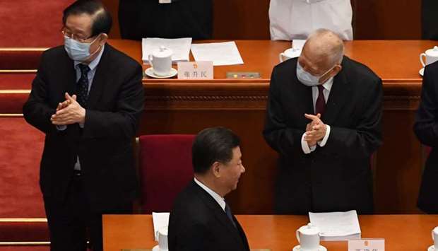 Chinese President Xi Jinping walks past former Hong Kong chief executive Tung Chee-hwa (right) as he arrives for the opening session of the National Peopleu2019s Congress (NPC) at the Great Hall of the People in Beijing yesterday.