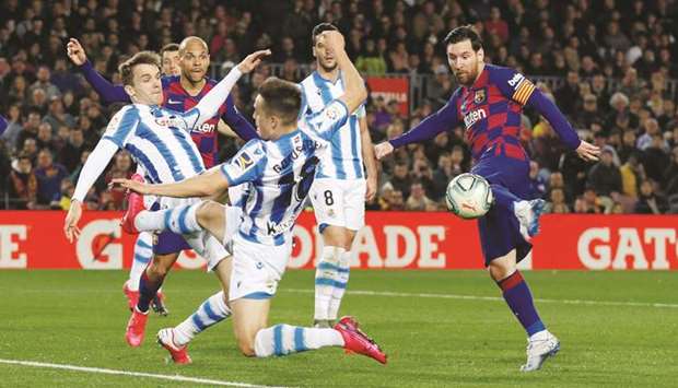 In this March 7, 2020, picture, Barcelonau2019s Lionel Messi (right) shoots at goal during the La Liga match against Real Sociedad at Camp Nou in Barcelona, Spain. (Reuters)