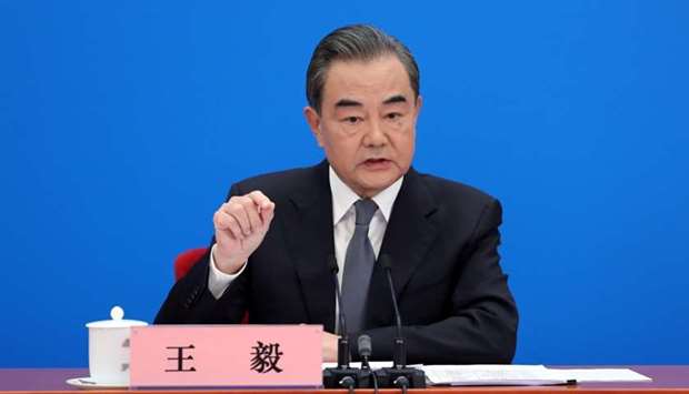 Chinese State Councillor and Foreign Minister Wang Yi speaks to reporters via video link at a news conference held on the sidelines of the National People's Congress (NPC), from the Great Hall of the People in Beijing