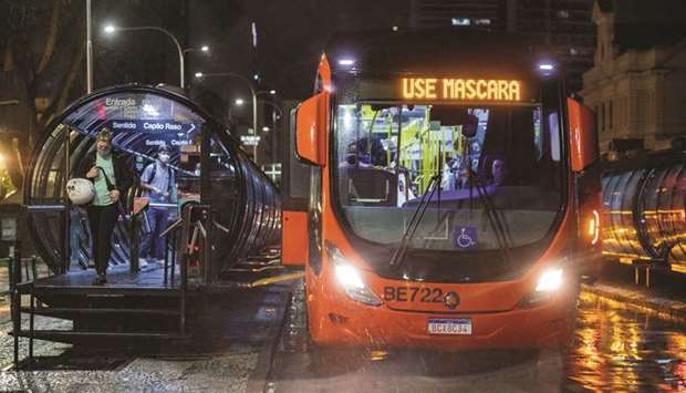View of a public bus with an electronic sign reading u2018Wear a face masku2019, in Curitiba, Brazil.