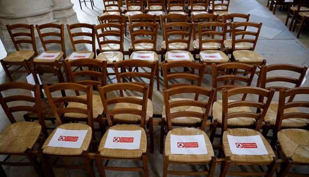 Signs are placed indicating to worshippers not to sit on certain seats at the Saint Germain lu2019Auxerrois church in Paris.