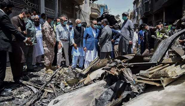 Aviation Minister Ghulam Sarwar Khan (in grey vest) with Sindh Governor Imran Ismail (in blue jacket) at the site of the Pakistan International Airlines aircraft crash.