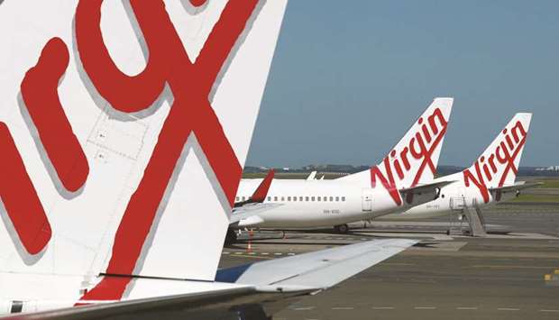 Grounded aircraft operated by Virgin Australia Holdings stand on the tarmac at Sydney Airport. Bain Capital is preparing a second-round proposal to become the owner and operator of Virgin Australia,  the US alternative asset manager said yesterday.