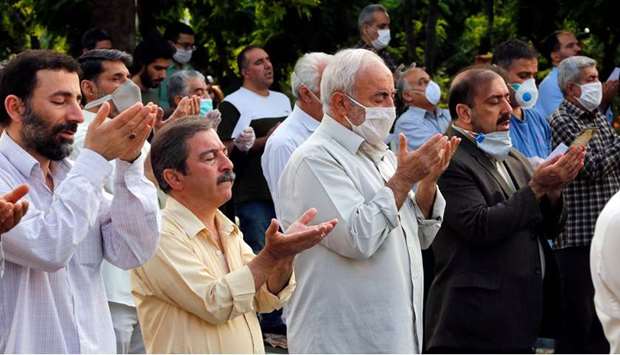 Worshippers, standing spaced from each other with some clad in masks as a measure against the Covid-19 pandemic, gather to attend the prayers of Eid al-Fitr, in Tehran, yesterday.