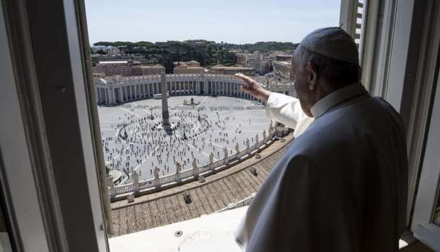 This photo issued by the Vatican Media shows Pope Francis saluting from the window of the apostolic palace overlooking St Peteru2019s Square after his live streamed Angelus prayer.
