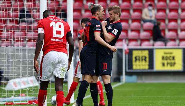 Leipzigu2019s German forward Timo Werner (right) celebrates with  Leipzigu2019s Slovenian midfielder Kevin Kampl after scoring a goal during their Bundesliga match against Mainz 05 in Mainz yesterday.  (AFP)