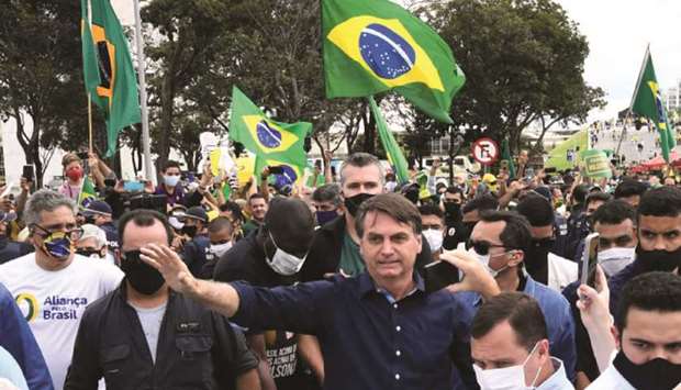 Brazilu2019s President Jair Bolsonaro greets supporters at Planalto Palace in Brasilia yesterday.