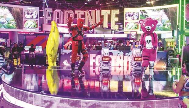 Character actors from the Epic Games Fortnite video game dance during the E3 Electronic Entertainment Expo in Los Angeles, California, on June 12, 2019.